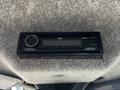JVC car stereo with Bluetooth functionality mounted on a grey felt surface