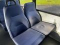 Two gray fabric seats designed for a passenger vehicle with a textured surface and contoured shape