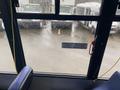 A 2018 Chevrolet Express bus with a wet windshield and visible raindrops on the glass