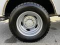 Close-up of a silver wheel and tire of a 2018 Ford F-550 featuring a six-bolt pattern and rugged tread design