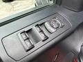 A control panel featuring window switches and a dial for adjusting side mirrors in a 2019 Ford F-150
