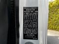 A 2015 Mitsubishi Fuso FE vehicle identification label with specifications and manufacturing details displayed prominently