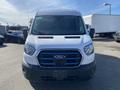 Front view of a white 2022 Ford Transit van with a distinctive grille and large windshield