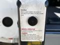 A 2019 Chevrolet Express with a lift mechanism and safety instructions labeled on the side of the lift platform