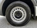 Close-up of a wheel from a 2020 Mercedes-Benz Sprinter featuring a black hubcap and all-season tire with a snowflake symbol indicating winter capability