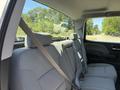 The back seat of a 2016 GMC Sierra 1500 features gray fabric upholstery and seat belts for three passengers