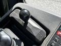Close-up of a black gear shift lever on a control panel of a 2010 John Deere 444K machinery