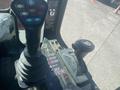 Control levers and joystick of a 2010 Trackless MT6 showing various buttons and labels for operation functions