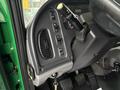 Interior dashboard of a 2015 Freightliner M2 106 featuring controls for lights and wipers along with the steering column and gear shift