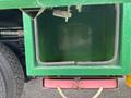 An empty green storage compartment with a rectangular shape and a smooth interior on a Freightliner M2 106 truck