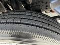 Close-up of a tire tread from a 2016 Isuzu NQR showing deep grooves and detailed rubber texture