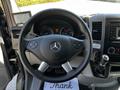 The interior view of a 2017 Mercedes-Benz Sprinter showing the steering wheel with the Mercedes logo and dashboard controls