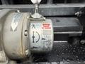 A hydraulic winch labeled Warn CE M8000 mounted on a vehicle showing signs of moisture and wear