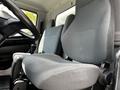 Interior view of a 2020 Hino 338 featuring the driver's seat and dashboard with a focus on the upholstery and armrests