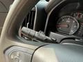 A close-up of the steering wheel of a 2016 Chevrolet Silverado 2500HD featuring the turn signal and windshield wiper controls