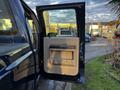 Interior view of the open door of a 2008 Ford F-250 SD showing the door panel and handle