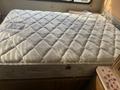 A 1987 Chevrolet Fleetwood Pace Arrow motorhome interior featuring a large queen-sized mattress on a bed frame with a quilted pattern