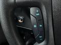 Close-up of a 2017 Chevrolet Express steering wheel control panel featuring buttons for cruise control and other functions