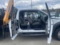 A 2017 Ford F-550 with its driver's side doors wide open showing spacious seating and interior layout