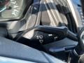 Black control lever for windshield wipers and turn signals in a 2017 Ford Transit vehicle interior