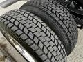 Close-up of the tread on two large tires from a 2019 Ford F-550 showing deep grooves and a rugged design for enhanced traction