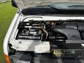 A 2004 Ford Econoline engine with visible components including a battery labeled Interstate and various mechanical parts