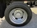 Close-up of a silver wheel with a six-bolt pattern and a black tire mounted on a 2018 Ford F-550