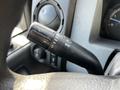 Close-up of the turn signal lever on a 2011 Ford F-450 SD showing turn indicators and headlight controls