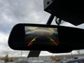 A rearview mirror display shows a 2011 Ford Econoline with guidelines for parking assistance