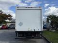 A white 2007 GMC W5500 18 foot cube van viewed from the rear with a blank back door and diamond-shaped marking on the left side