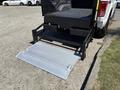 A 2016 Ford F-150 with a lowered tailgate and an attached loading ramp for easy access to the truck bed