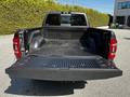 A black 2022 RAM 3500 pickup truck with an open bed showing a rubber liner and no cargo inside