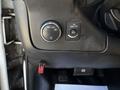 Dashboard controls of a 2017 Chevrolet Express including a light switch and a toggle button for the dome light