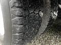 Close-up of a worn tire tread from a 2013 Ford Econoline displaying cracks and uneven wear patterns
