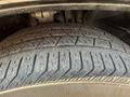 Close-up of a tire from a 2020 Alfa Romeo Stelvio showing tread pattern and details of the rubber surface