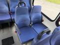 Two blue upholstered seats with seat belts in a 2020 Chevrolet Express van interior
