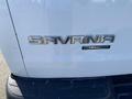 The rear of a 2012 GMC Savana van featuring the model name Savana and the Stabilitrak logo in chrome letters