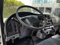 Interior view of a 2010 Freightliner M2 106 showing the steering wheel dashboard controls and gear shift