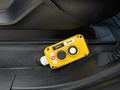 A yellow control switch with buttons for up, down, and a toggle switch located on the interior console of a 2017 Ford F-550