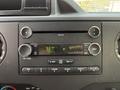 Dashboard of a 2011 Ford Econoline showing audio controls and display for radio station and time
