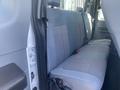 Interior view of a 2014 Ford F-250 SD featuring a gray cloth bench seat in the rear passenger area
