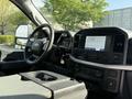 Interior view of a 2021 Ford F-150 showing the steering wheel dashboard and center console