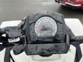 Close-up of the speedometer and handlebar of a 2017 Polaris Scrambler displaying the speed and mileage on a rainy day