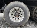 Close-up of a tire mounted on a silver rim for a 2018 Kenworth T800 featuring tread patterns and visible wear marks on the rubber surface