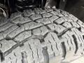 Close-up of a rugged tire with deep treads designed for off-road performance on a 2015 Ford F-350 SD