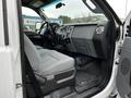 Interior of a 2016 Ford F-550 featuring a gray cloth seat and dashboard with controls and air vents visible