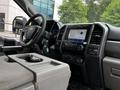 Interior of a 2020 Ford F-350 SD showing the steering wheel dashboard and center console with touchscreen display and controls