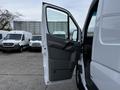 A 2016 Mercedes-Benz Sprinter with the driver's side door open showcasing the interior door panel and handles