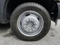 Wheel of a 2016 Ford F-550 featuring a silver rim and a large all-terrain tire with deep treads