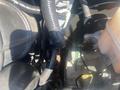 A close-up view of the engine components in a 2009 Ford Econoline including hoses and electrical wiring